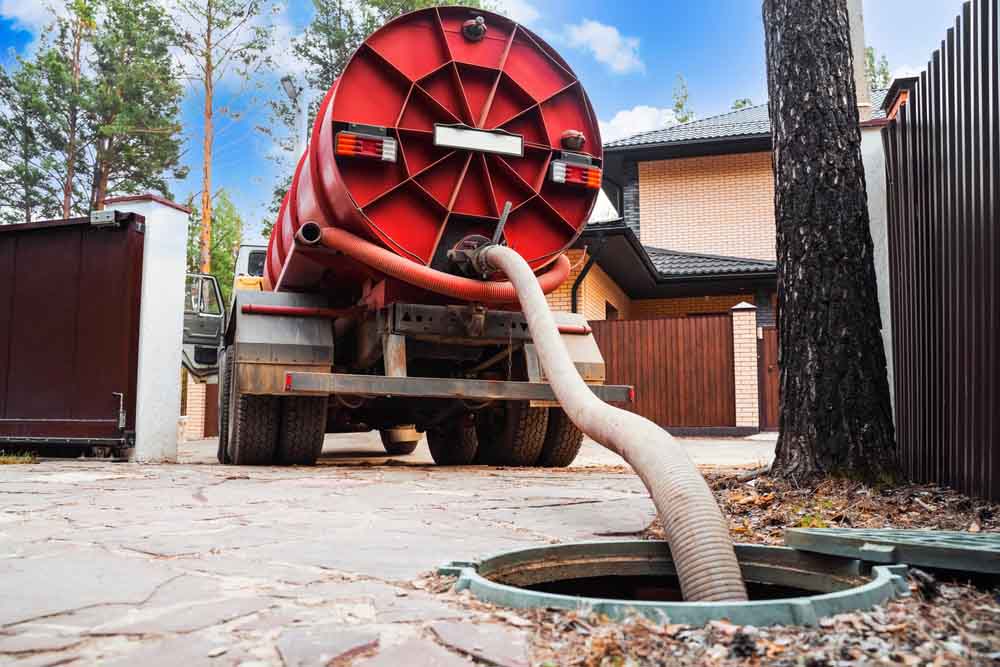 Sloan’s Septic technician pumping a septic tank