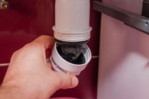 Sloan’s technician cleaning a clogged drain